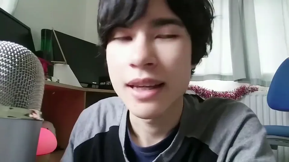 Daniel speaking close to a large microphone in a fan-preserved video excerpt