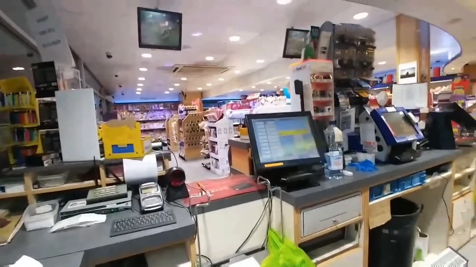 A retail checkout workspace with tills, payment terminals, and merchandise displays
